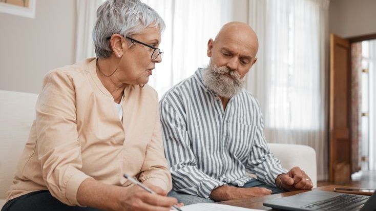 A married couple in their 60s discusses their financial plan. 